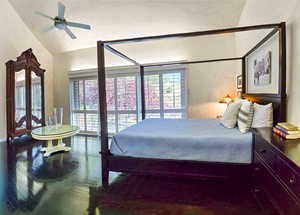 Primary bedroom featuring lofted ceiling, ceiling fan, and hardwood flooring. With view to the East deck and pool.