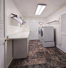 Clothes washing area with washing machine and dryer, counter space and cabinets