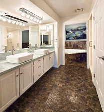 Primary Bathroom featuring double sink vanity, shower with separate jetted bathtub