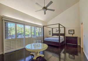 Primary Bedroom with high vaulted ceiling, ceiling fan, and dark hardwood / wood floors. With view to the East deck and pool.