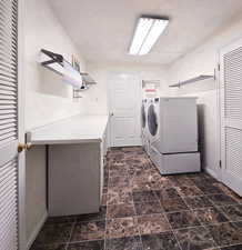 Clothes washing area with washing machine and dryer, counter space and cabinets