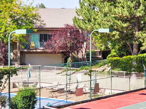 View of property exterior showing proximity to community ammeneties pool and tennis courts