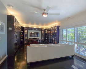 Media / Library room featuring ceiling fan with a view to West Deck