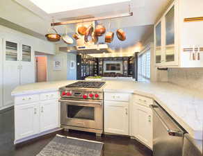 Kitchen with White cabinets and white Carrara marble counters