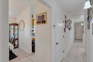 Hall with light tile patterned floors