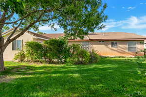 Rear view of property featuring a lawn