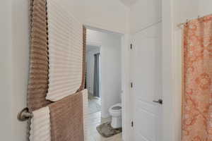 Bathroom featuring tile patterned flooring and toilet