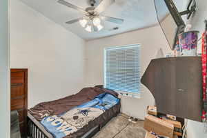 Carpeted bedroom featuring ceiling fan