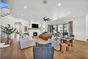 Living room with light hardwood / wood-style flooring and ceiling fan