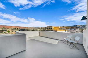 View of patio with a balcony and a mountain view