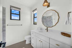 Bathroom featuring tile patterned floors, vanity, and toilet