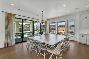 Dining room with dark hardwood / wood-style flooring