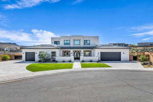 View of front of home featuring a front yard and a garage