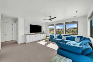 Living room featuring ceiling fan and light colored carpet