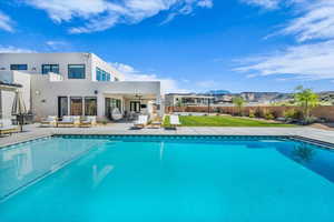 View of pool featuring an outdoor hangout area, ceiling fan, a mountain view, and a patio area