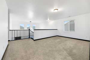 Spare room with light colored carpet and plenty of natural light