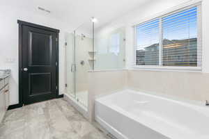 Bathroom with vanity and separate shower and tub