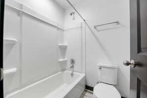 Bathroom with shower / washtub combination and toilet