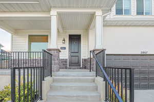 View of exterior entry with a garage