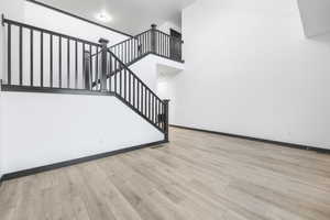 Stairway featuring hardwood / wood-style floors