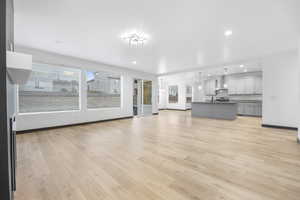 Unfurnished living room with light hardwood / wood-style floors