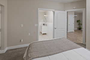 Carpeted bedroom with ensuite bath