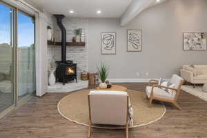 Living area with a wood stove and dark hardwood / wood-style flooring