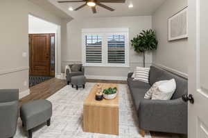 Living room featuring ceiling fan and hardwood / wood-style flooring