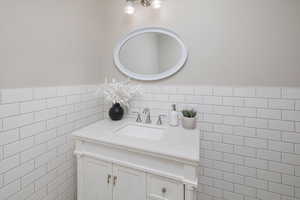 Bathroom with tile walls and vanity