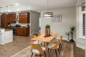 Dining area with a chandelier, dark wood-type flooring, and washer / dryer