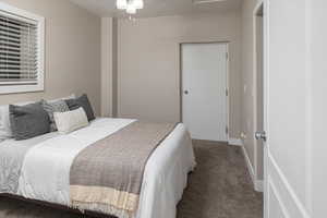 Bedroom featuring a textured ceiling and carpet