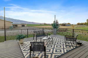 Wooden deck featuring a rural view and a mountain view