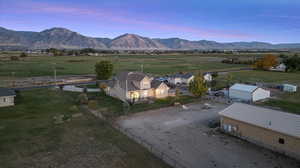 Aerial view at dusk featuring a mountain view