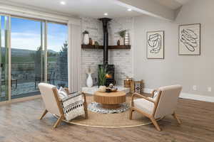 Living area with a wood stove and wood-type flooring