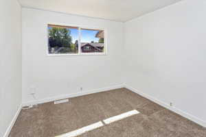 Unfurnished room featuring carpet