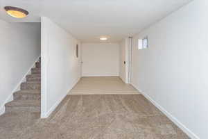 Hall featuring carpet floors and a textured ceiling