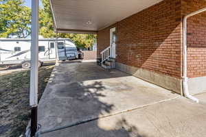 View of patio with a carport