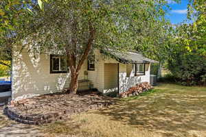 View of side of property featuring a lawn and central AC unit