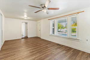 Unfurnished room with ceiling fan and hardwood / wood-style floors