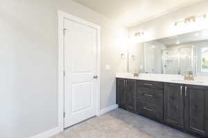 Bathroom featuring vanity and a shower with shower door