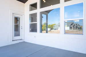 Doorway to property featuring a patio