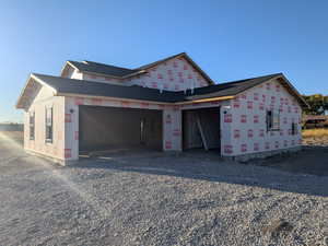 View of side of property featuring a garage