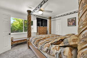 Bedroom featuring ornamental molding, a closet, ceiling fan, and carpet floors