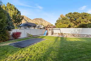 View of yard with a playground and a mountain view