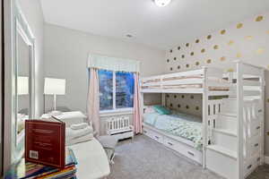 Carpeted bedroom with a textured ceiling