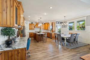 Dining room featuring light hardwood / wood-style floors, an inviting chandelier, and sink