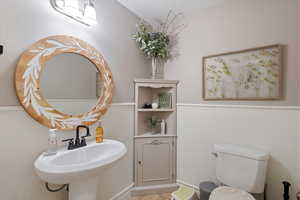 Bathroom with sink, tile patterned floors, and toilet