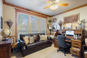 Carpeted home office featuring ornamental molding, crown molding and ceiling fan