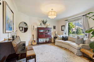 Living room with ornamental molding along with crown molding and hardwood / wood-style flooring