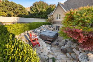 View of yard featuring a hot tub and a patio area